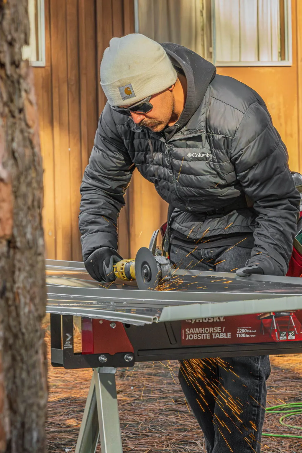 Crew member measuring and marking a standing seam panel