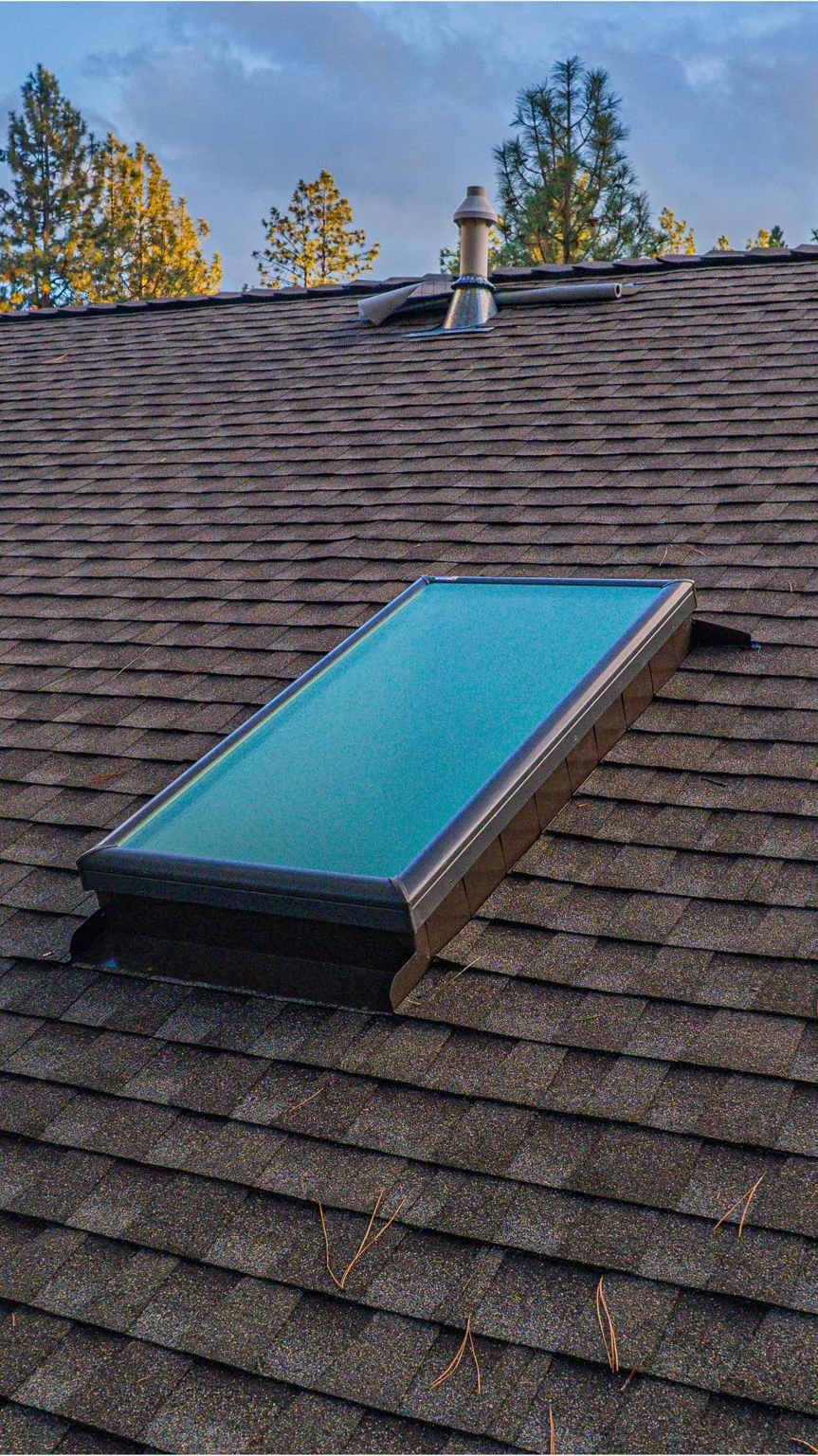 New skylight set into the finished shingle roof