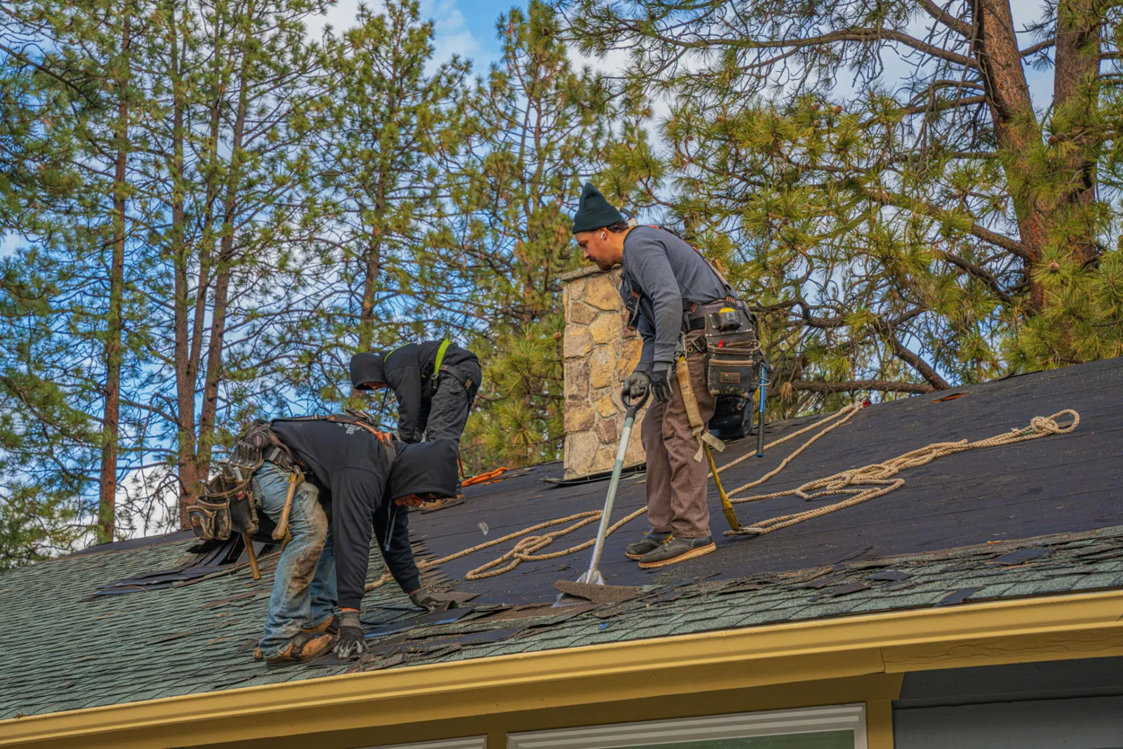 Tear-off in progress on the chimney side of the roof