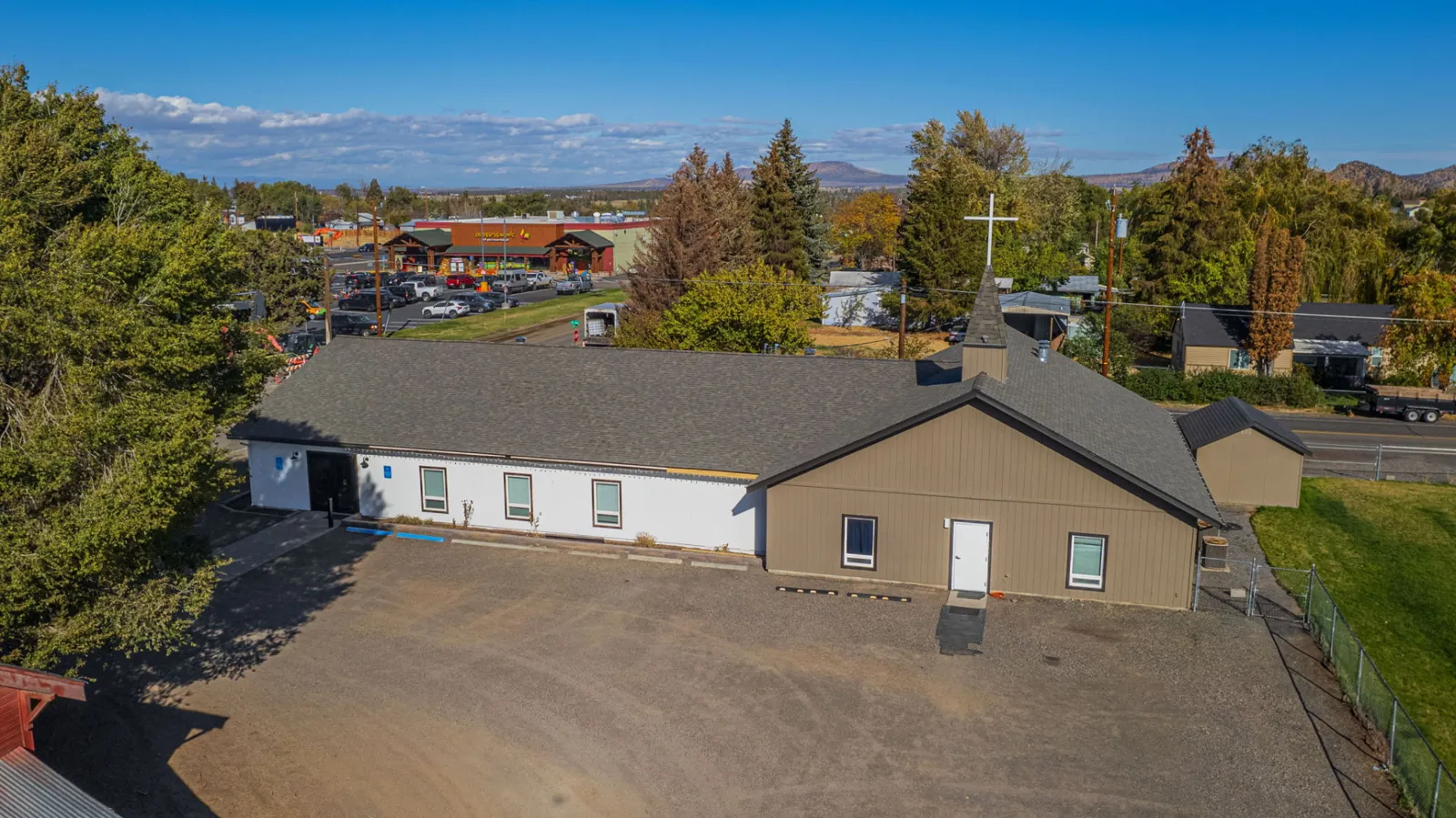 Finished church building with its completed roof under a clear Central Oregon sky