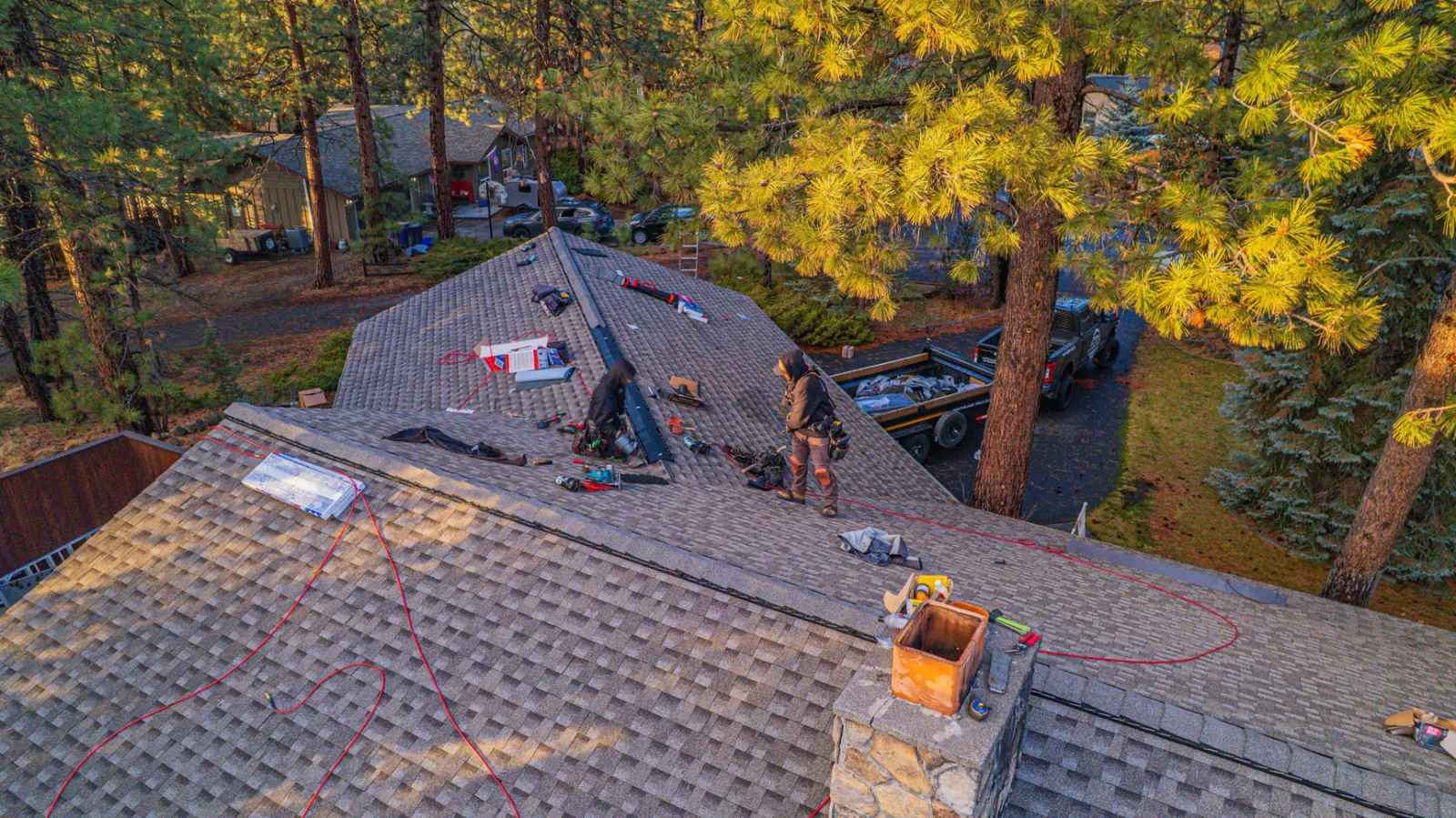 Newly installed composition shingles covering the main roof plane