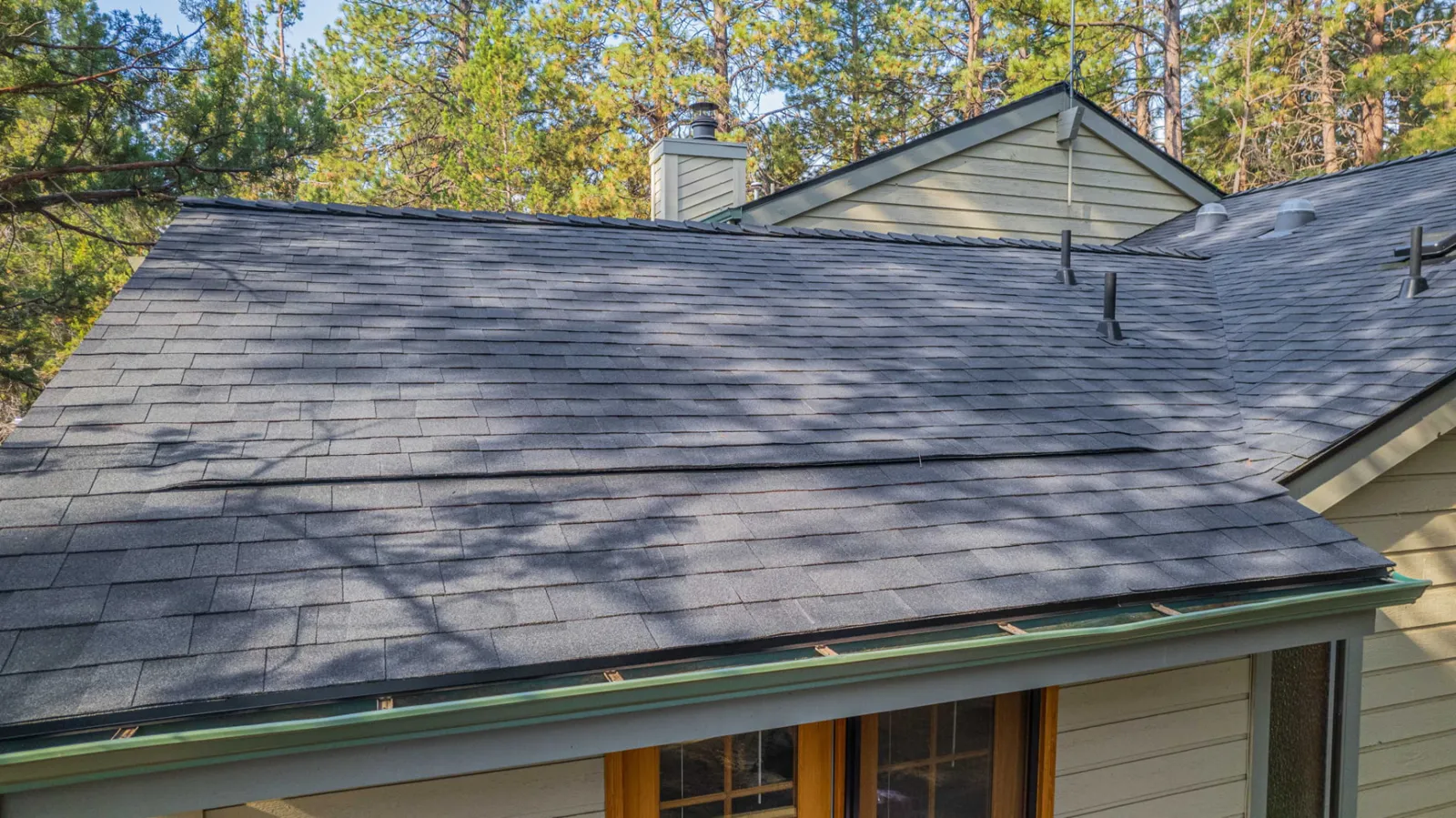 Clean shingle roof plane and ridge line on a maintained Central Oregon home
