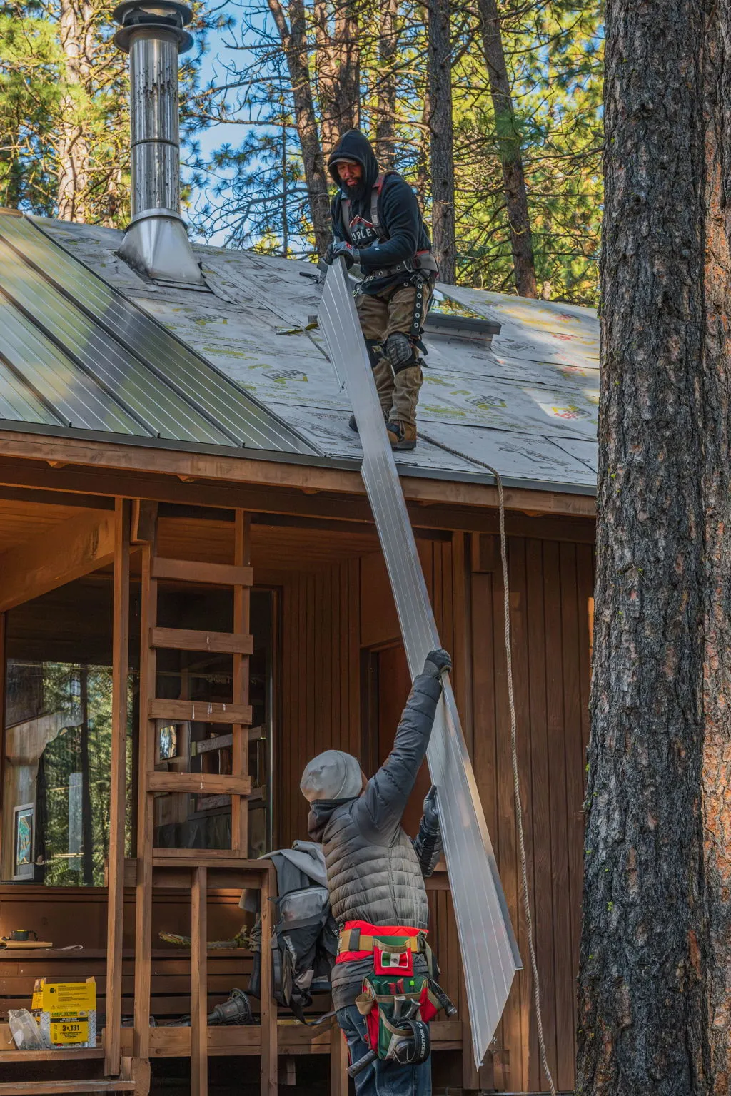 Metal panel carried up to the roof for installation