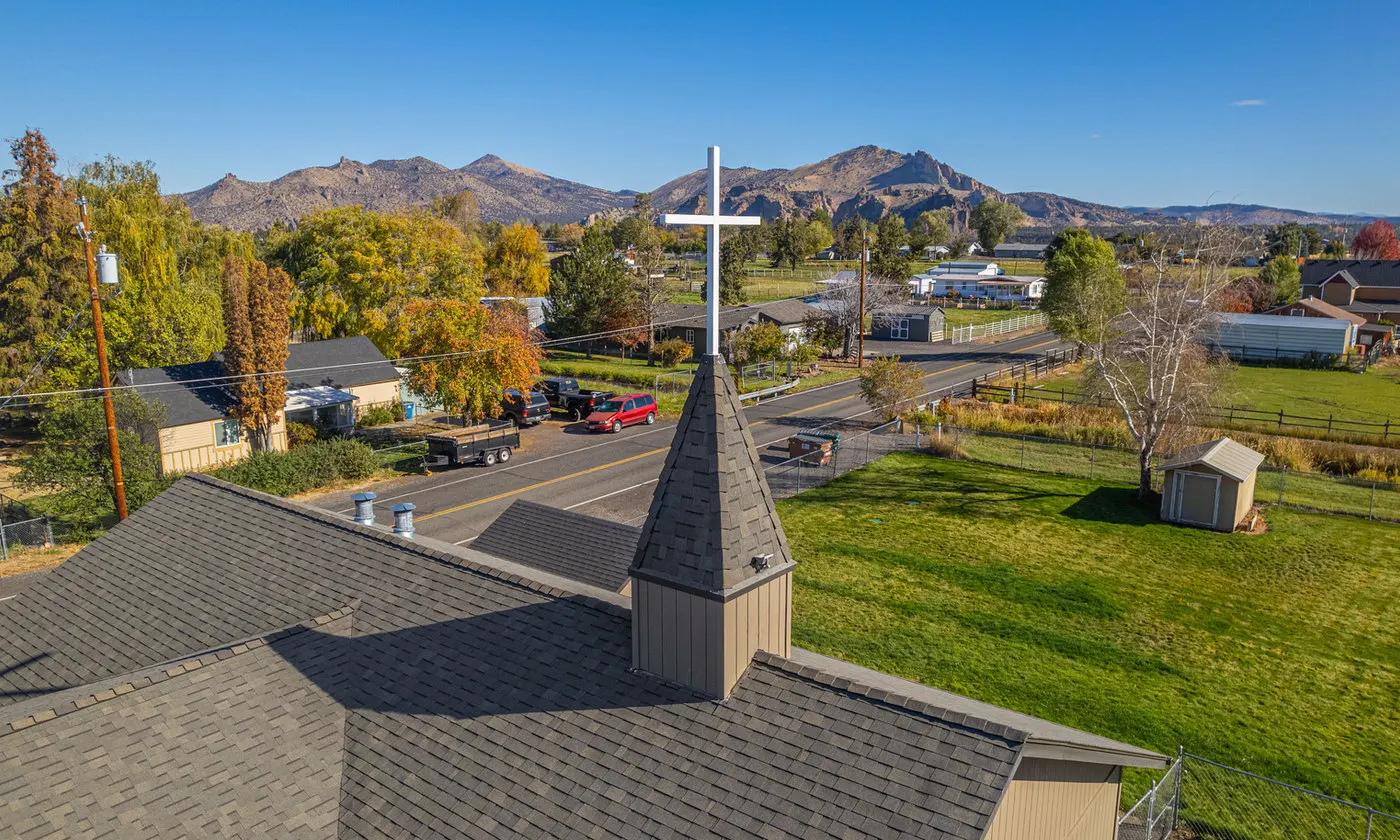 Commercial church roof in Central Oregon with Smith Rock in the background