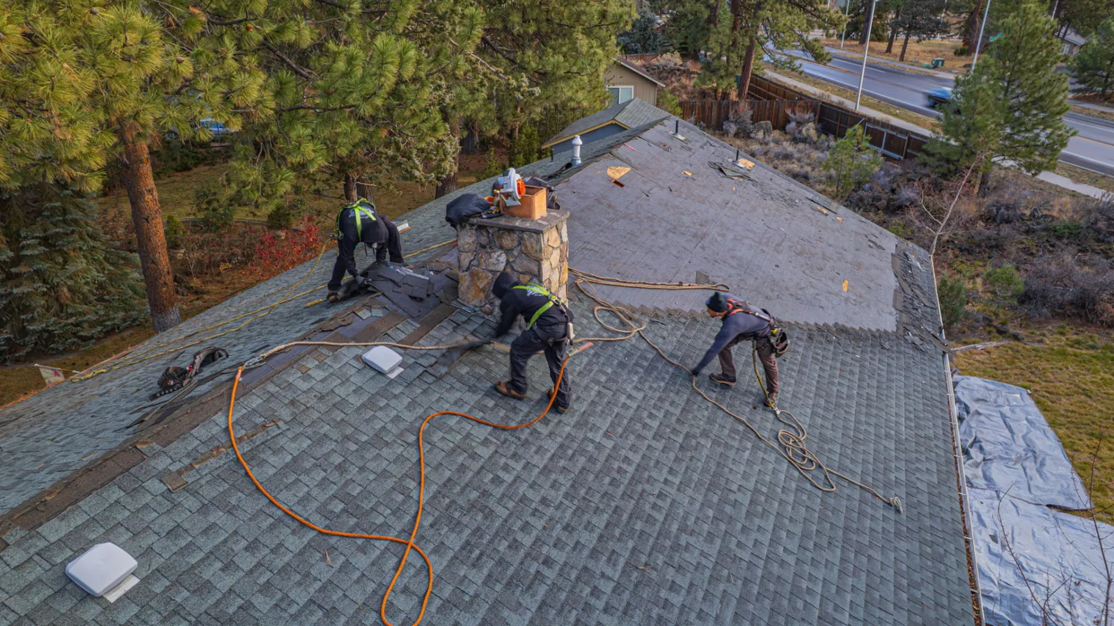 Crew working across the dried-in roof before shingles go on