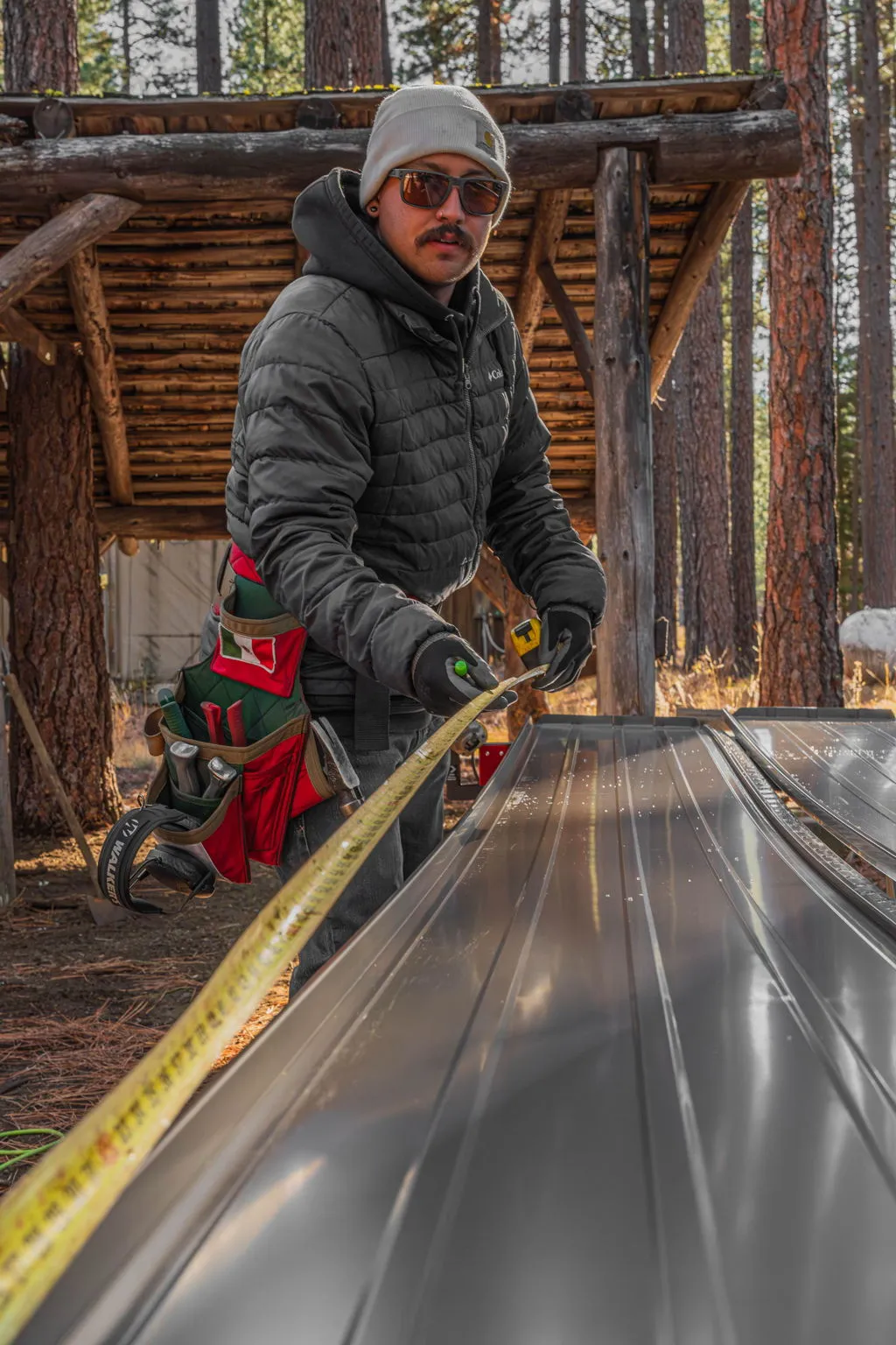 Metal roof panel being cut to length on site